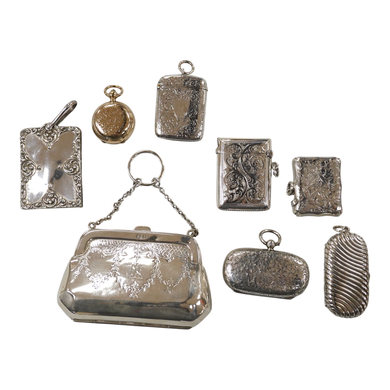 Two late Victorian silver twin compartment sovereign cases, Birmingham, 1891 & 1896, both approx. 57mm, a gold plated sovereign case, together with three silver vesta cases, a silver purse and a silver mounted notebook.